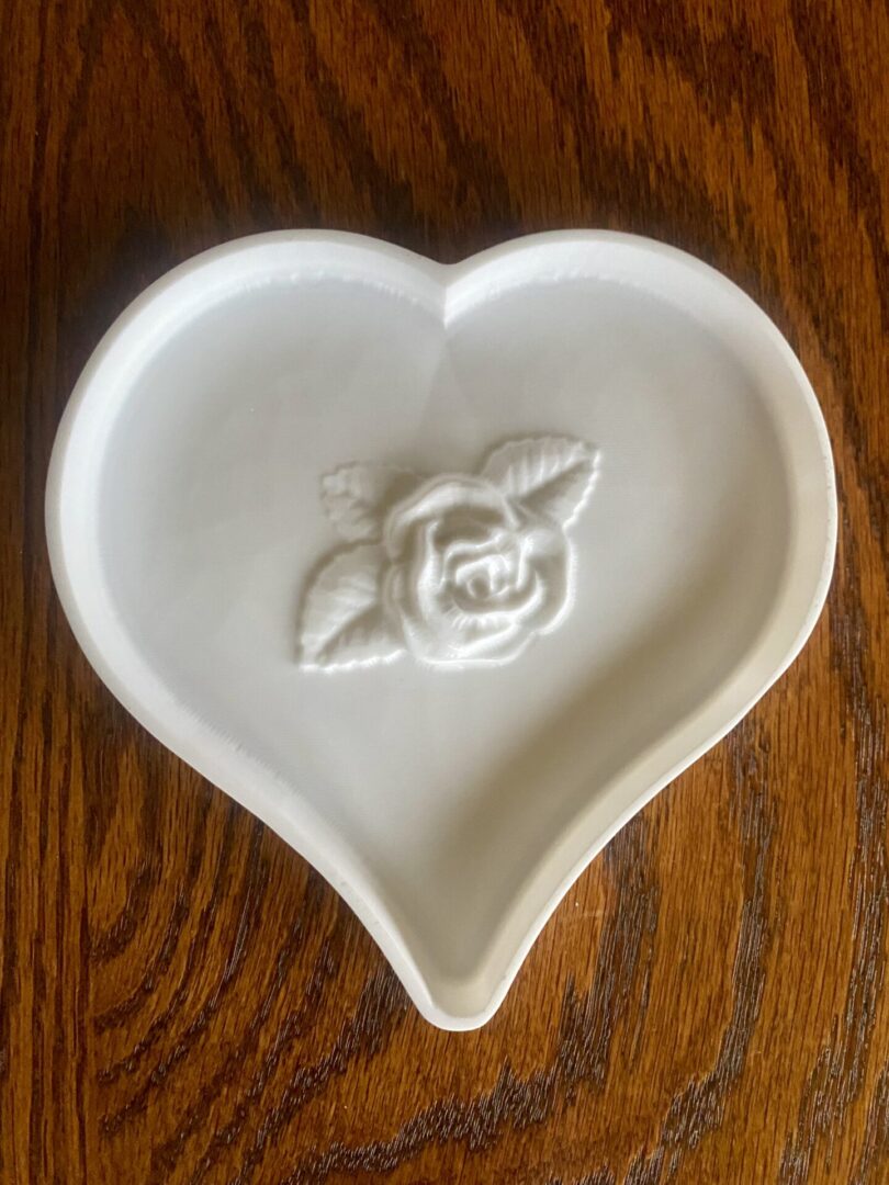 Heart-shaped dish with rose design.