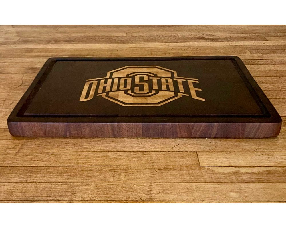 Ohio State cutting board on wooden surface.