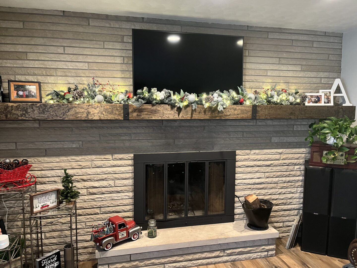 Fireplace with TV and festive decorations.
